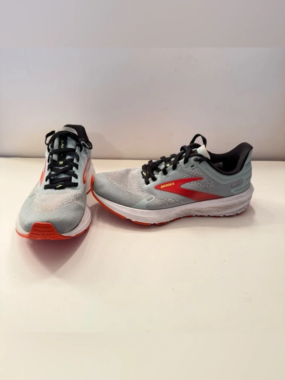 Brooks Light Gray Running Shoes with Red and Orange Accents